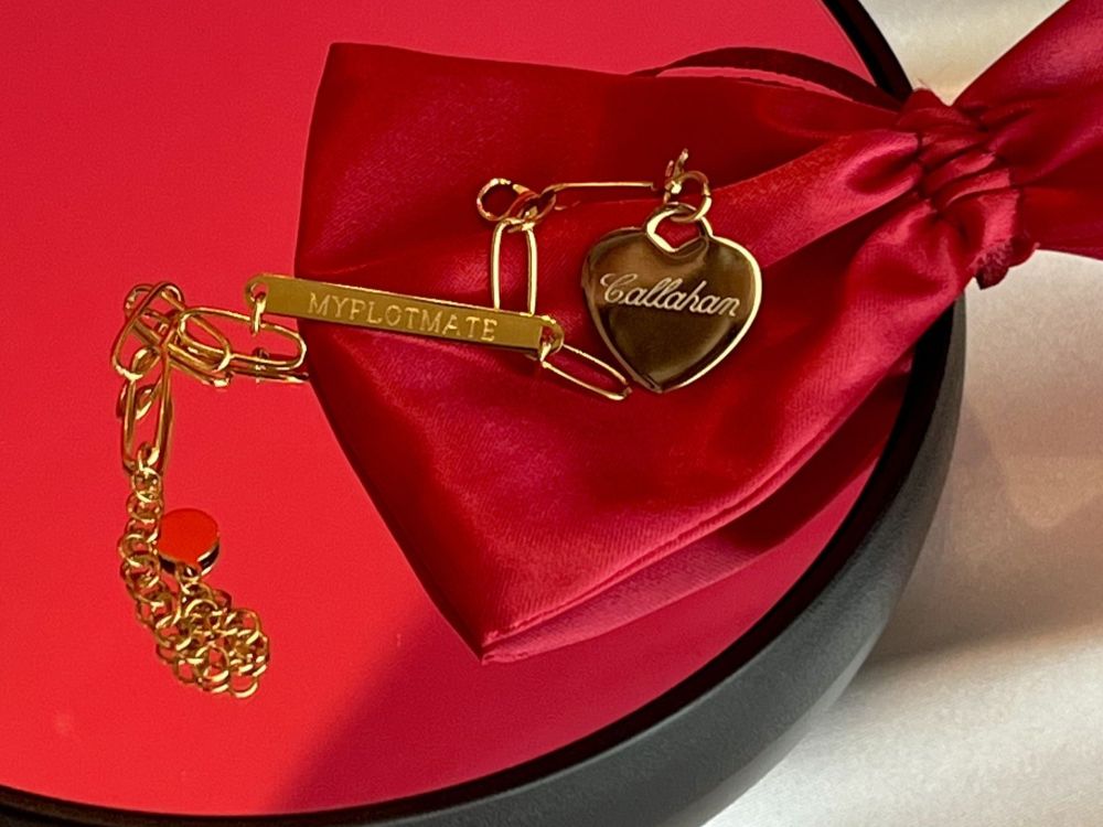 The gold bracelet with Callahan engraved charm made for Love Me Stalk Me by Laura Bishop.