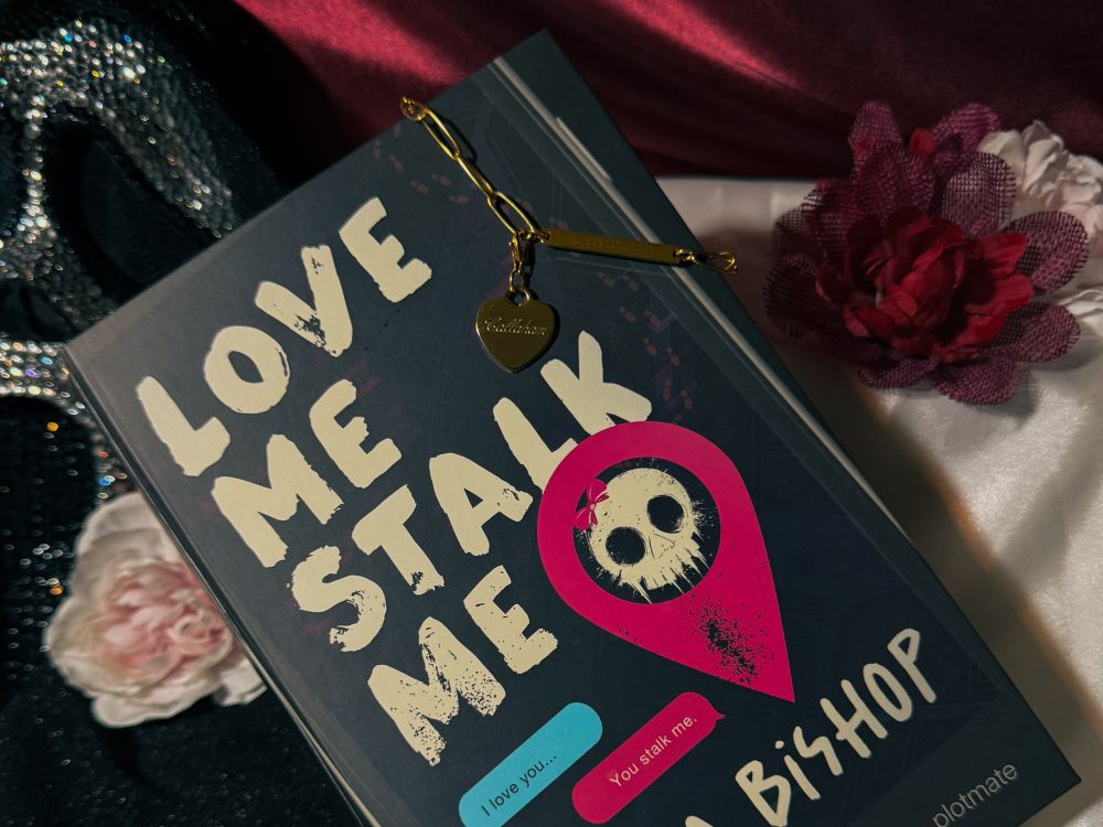 The gold bracelet from Callahan on top of its book-like package for Love Me Stalk Me by Laura Bishop.
