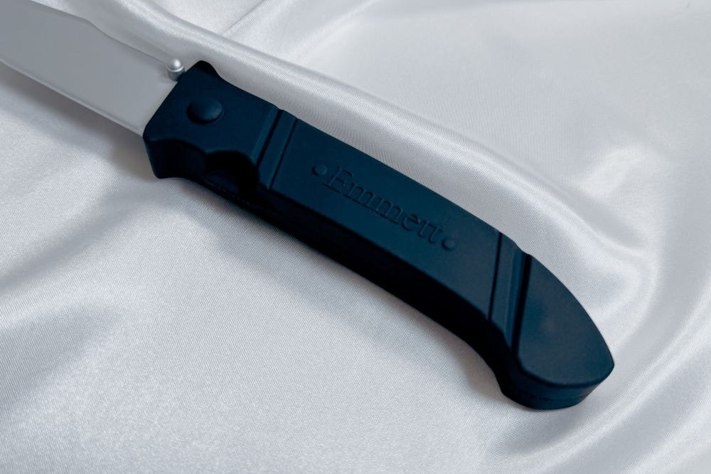 The hilt of the silicone knife toy for Pretty Little Fears by S.J. Ryder with its Emmett degraving.