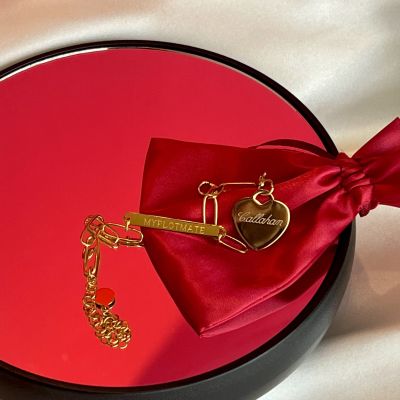 A custom gold charm engraved with Callahan, the MMC from Love Me Stalk Me.
