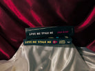 The Callahan book box next to the dark romance book Love Me Stalk Me by Laura Bishop.