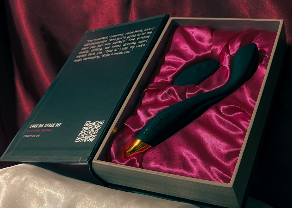 An opened book box presenting Callahan with its remote, the official adult toy from the dark romance book Love Me Stalk Me by Laura Bishop.