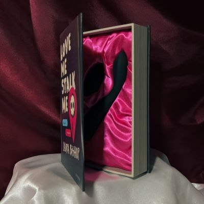 The opened box for the dark romance book Love Me Stalk Me presenting the toy Callahan.