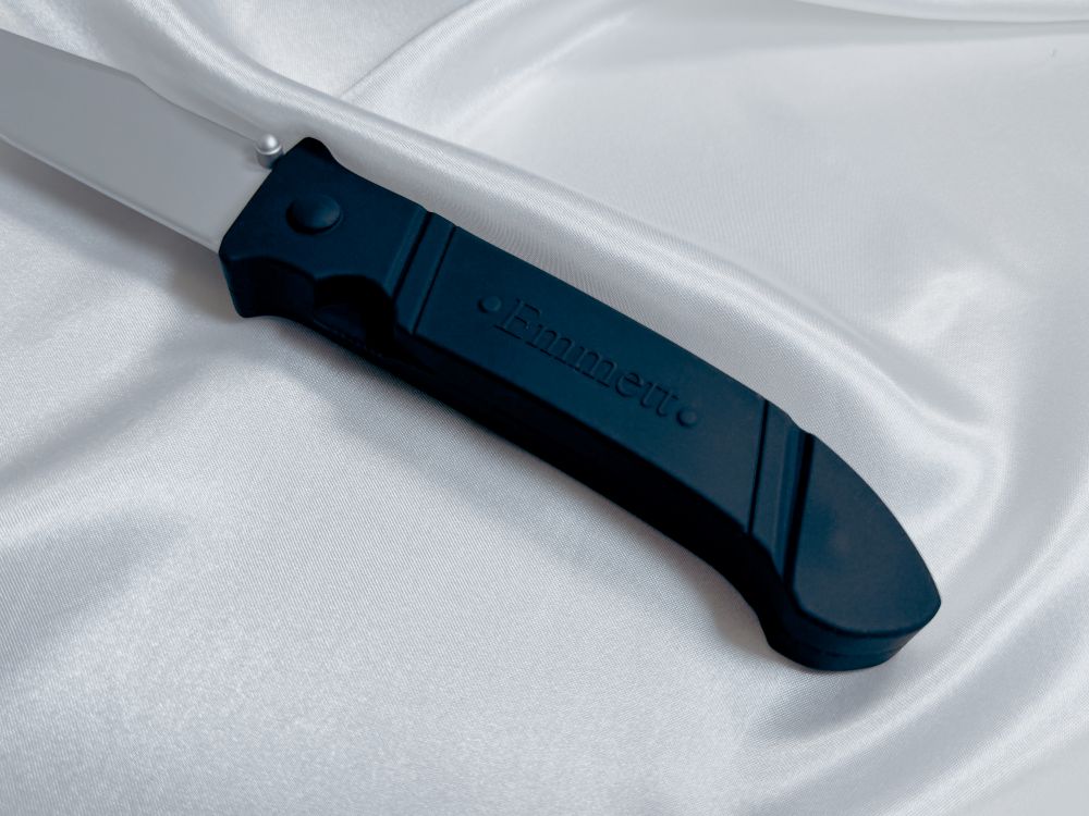 The hilt of the silicone knife toy for Pretty Little Fears by S.J. Ryder with its Emmett degraving.