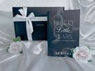 The book Pretty Little Fears by S.J. Ryder in front of a myplotmate box with a white ribbon and two roses next to it.