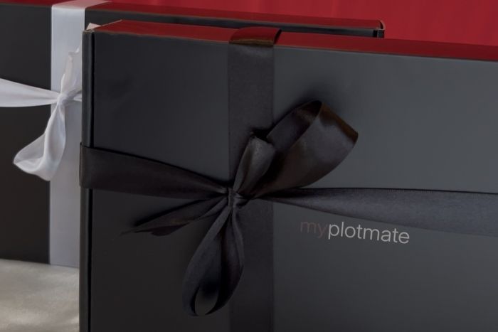 myplotmate mailer boxes with white and black ribbon.