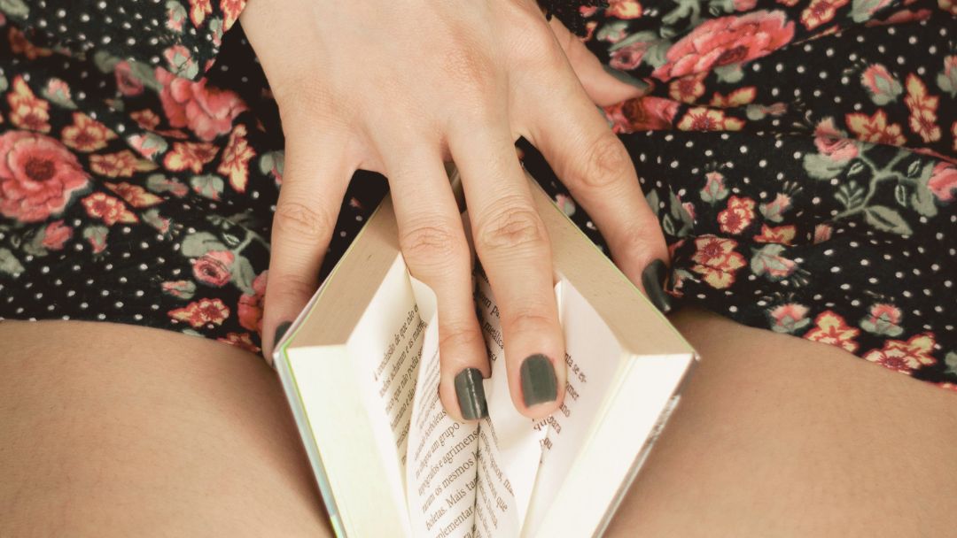Woman spreading book pages with her fingers