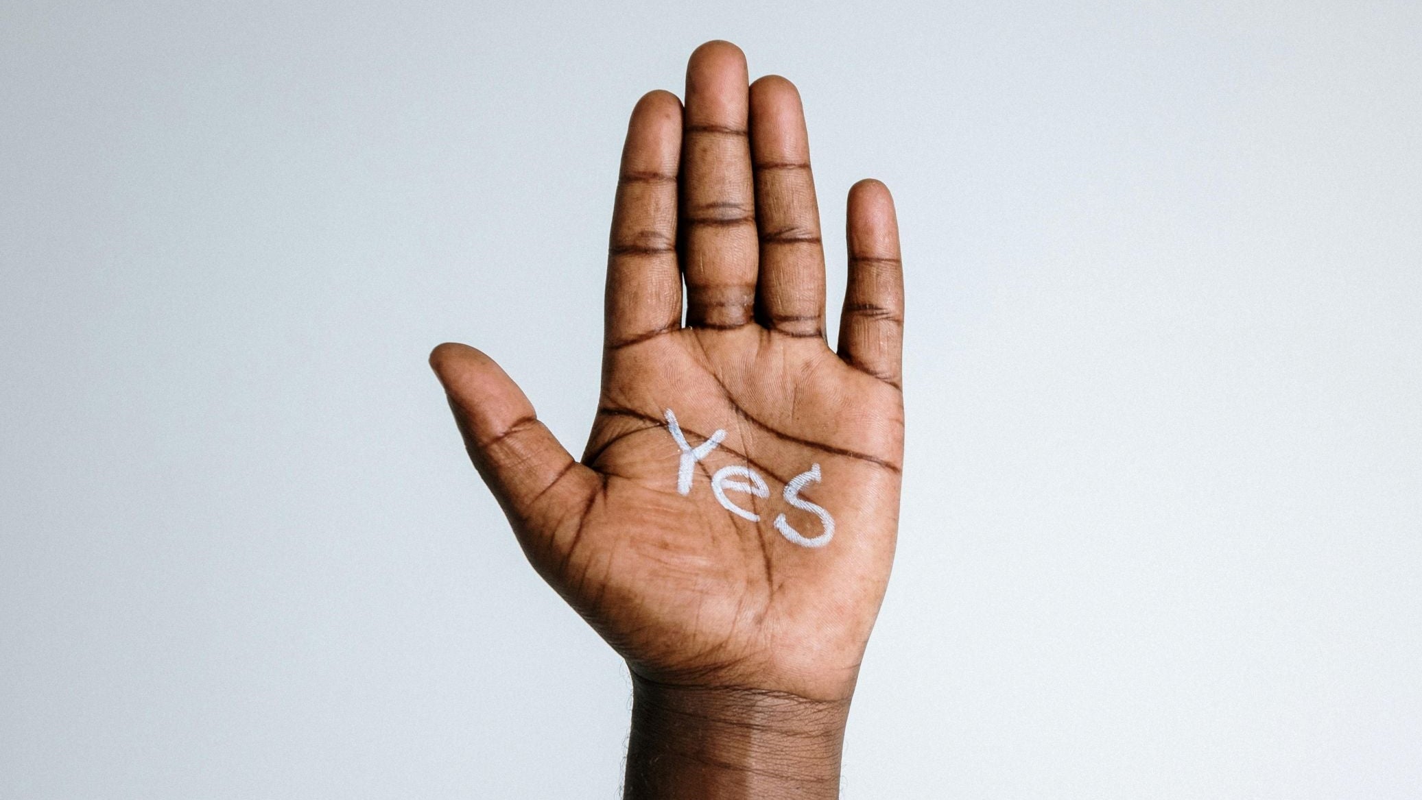 A hand with Yes written on its inside.