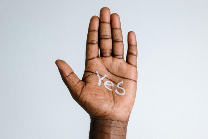 A hand with the word yes written on it.