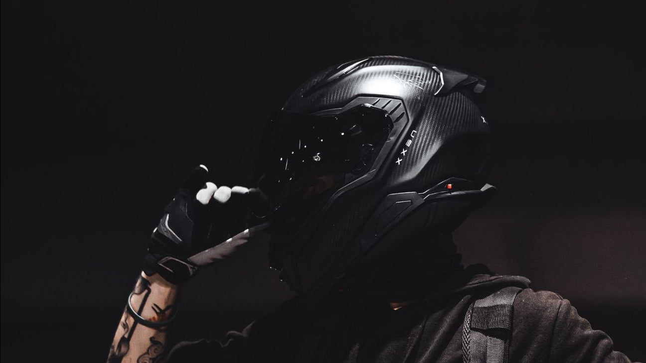A dark romance biker wearing a helmet.